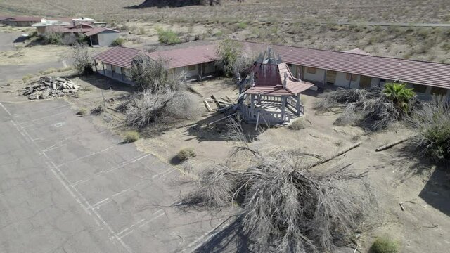 Abandoned vacation resort hotel building with gazebo at Lake Mead Boulder City Las Vegas Nevada desert aerial drone 4k ungraded flat log raw dlog footage