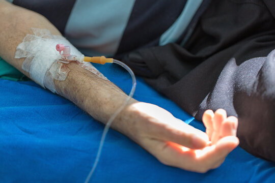Close up hand of old patient with intravenous catheter