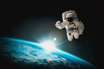 Naklejka na ściany i meble Astronaut spaceman do spacewalk while working for space station in outer space . Astronaut wear full spacesuit for space operation . Elements of this image furnished by NASA space astronaut photos.