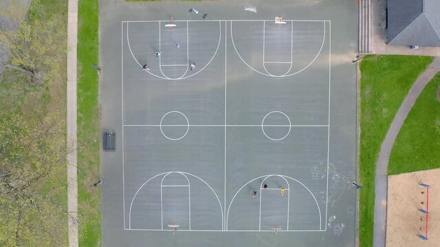 Top down aerial of basketball court at school in USA. American athletics are important aspects of teenagers and college students. Sports and fitness theme.