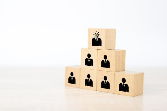 Human and business people, Man icon on cube wooden block stack in pyramid. Concepts of human resources personnel selection and person organization job fit and employees performance.