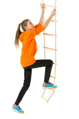 Teenage girl climbing rope ladder. Isolated over white background.
