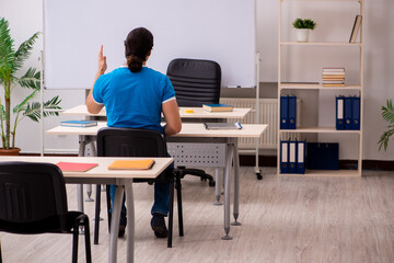 Young male student in the classroom