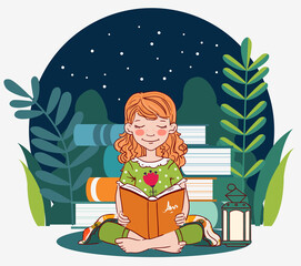Cute, little girl reading a book in the garden