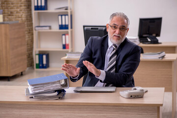 Aged businessman employee sitting in the office