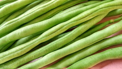 Fresh green bean pods, a type of edible legume, are a healthy green food rich in protein
