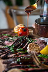 Sliced steak on a board with bordelaise sauce