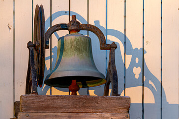 Closeup isolated image of a rusty church bell immobilized on wooden blocks through metal framing....