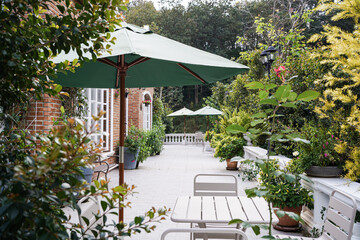 Fototapeta na wymiar garden furniture and sun umbrella, garden with family relaxing zone, balcony