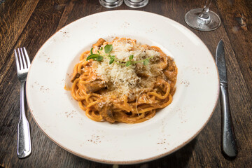 Pasta with meat, tomato sauce and parmesan cheese.