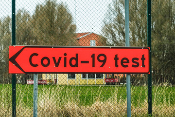 Norrtalje, Sweden April 23, 2021 A red Covid-19 test road sign.
