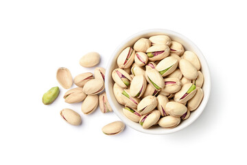 Flat lay of pistachio nuts in white bowl isolated on a white background.