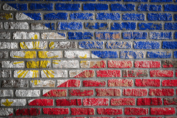 National flag of Philippines depicting in paint colors on an old brick wall. Flag  banner on brick wall background.