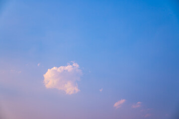 lonely soft clouds floating on blue sky,One white fluffy cloud floating in sky of blue in spring,Anime cloud image,A single puff of a cumulus cloud floats in the air,Cloud images of pink-blue tones.