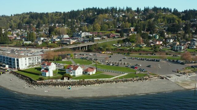 Flying Right to Left over Small town with Lighthouse