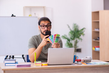 Young male designer working in the office