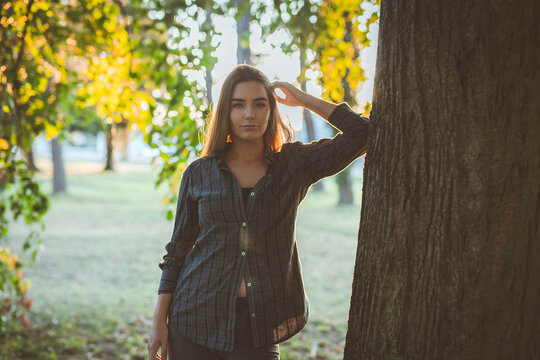 Beautiful Blonde Caucasian Woman Wearing Flannel Posing In The Park