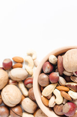 assorted nuts in ceramic dishes and nuts scattered on a white background top view assorted nuts	
