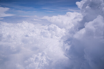 Atmosphere beautiful blue sky with clouds form plane. Flying above the clouds. Clouds blue sky High angle air. Background Clouds. A view from airplane window. View along the way.
