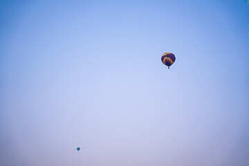 A balloon floating in the sky,A  balloon high in the sky. There is a blue sky . view from below.