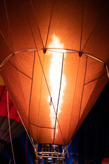 Firing in a balloon from burner,ballooning, view of the flame inside of a hot air balloon being inflated. Hot Air Balloon burners in operation,fire pumping warm air into a red balloon.