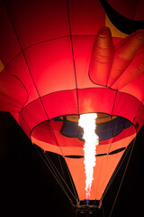 Firing in a balloon from burner,ballooning, view of the flame inside of a hot air balloon being inflated. Hot Air Balloon burners in operation,fire pumping warm air into a red balloon.