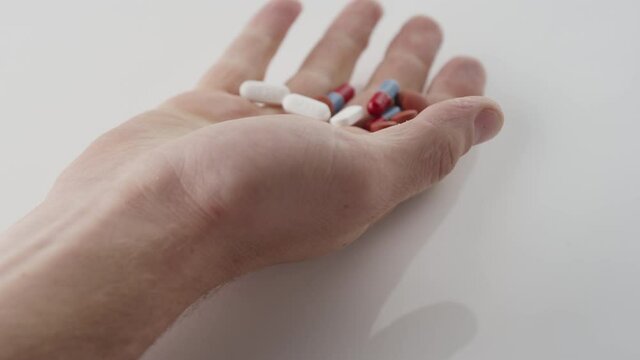 Slow motion shot of a handful of pills from an overdose