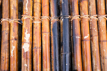 Bamboo rafting by a picturesque river in tropical jungles,yellow bamboo tied into the raft floating...