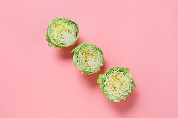 Fresh cut cabbages on color background