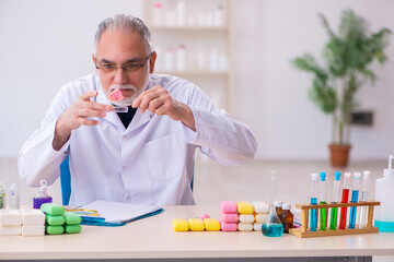 Old male chemist testing soap in the lab