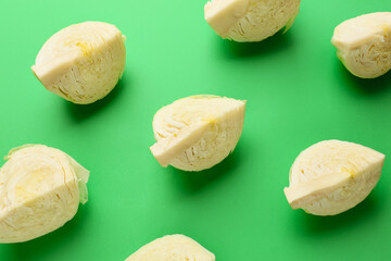 Fresh cut cabbages on color background