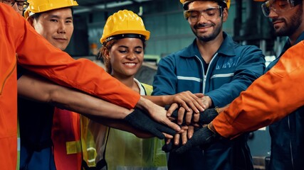 Skillful worker stand together showing teamwork in the factory . Industrial people and manufacturing labor concept .