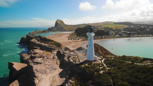 Castlepoint Lighthouse Tower on Rocky Coast of North Island, New Zealand - Aerial Shot