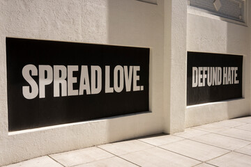 Spread Love. Defund hate. Positive slogans painted on boarded-up windows during protests.