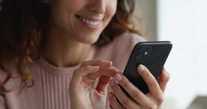 Close up female hands holding smartphone using mobile application, e-commerce client, e-shopping and user of electronic commercial retail services. Modern technology usage for fun, work, hobby concept