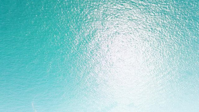 Aerial view never endless sea surface view, Tropical beach water background. Soft wave of emerald clear sea