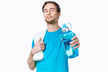 sporty man in blue t-shirt water bottle towels workout