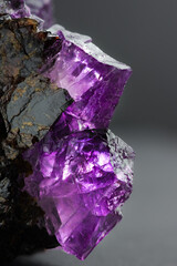 Fluorite gemstone (fluorspar) purple pink  crystals inclusion with modern dark background detail cloe-up