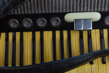 Old musical accordion isolated on dark background.
