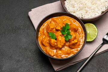 Plate of Traditional Chicken Curry and rice on dark concrete background