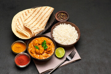 Plate of Traditional Chicken Curry and rice on dark concrete background