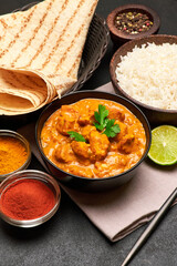 Plate of Traditional Chicken Curry and rice on dark concrete background