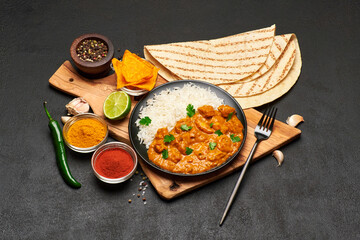 Plate of Traditional Chicken Curry and rice on dark concrete background