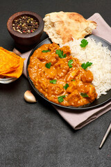 Plate of Traditional Chicken Curry and rice on dark concrete background