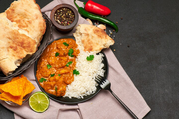 Plate of Traditional Chicken Curry and rice on dark concrete background