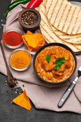 Plate of Traditional Chicken Curry and rice on dark concrete background