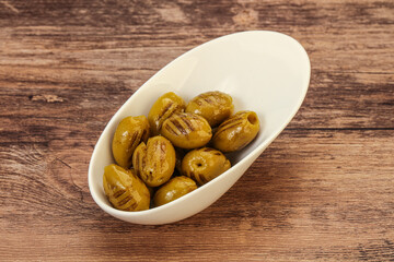 Green grilled olives in the bowl