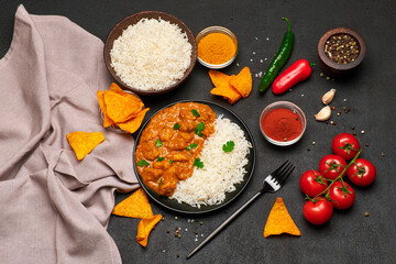 Plate of Traditional Chicken Curry and rice on dark concrete background
