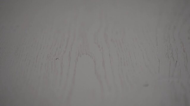 Slow motion handheld shot of white oak surface closeup