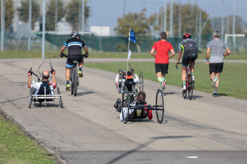 Disabled Athletes training with their Hand Bikes with Cyclist and Runners Close to Them